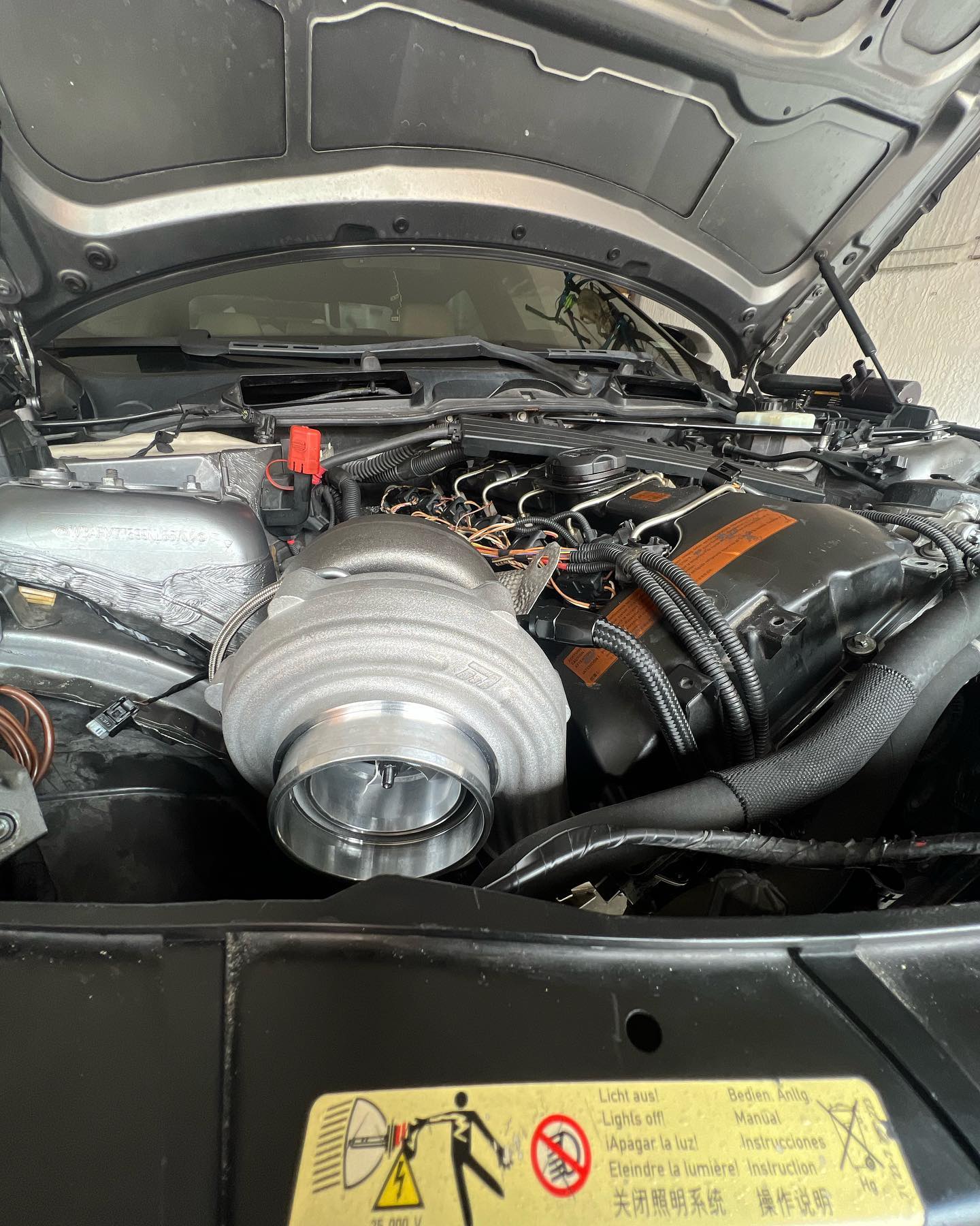 BMW N54 engine bay with turbo upgrade installed by BMW Geeks