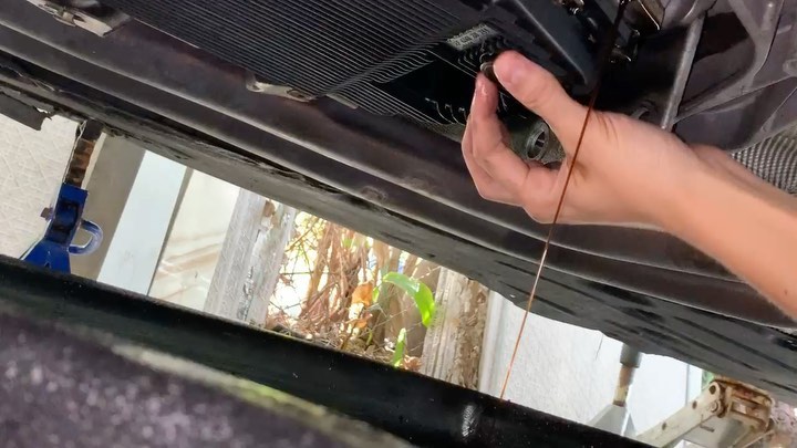 Mobile mechanic working on BMW cooling system